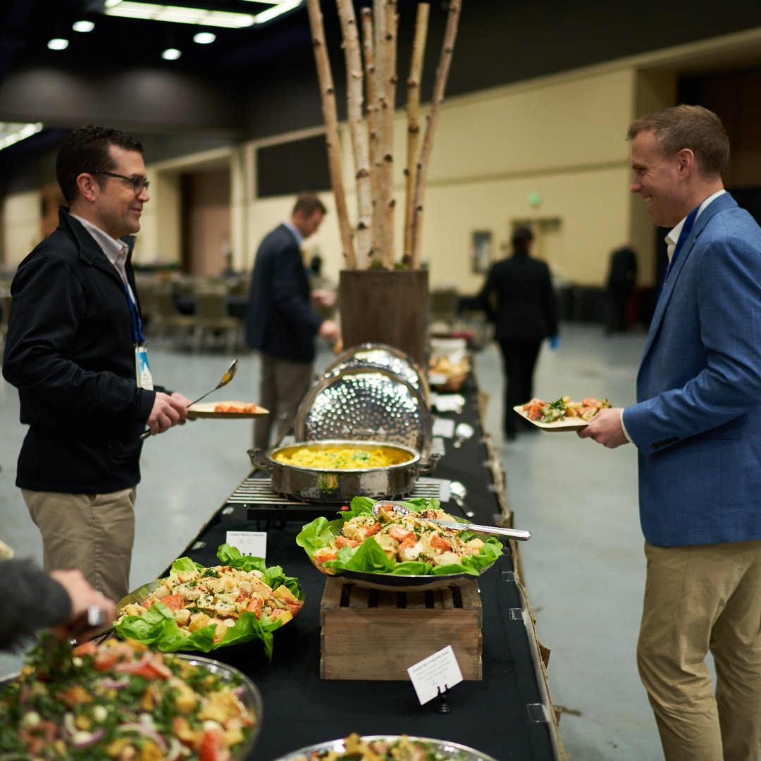 People getting food at a buffet table